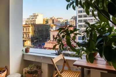 a balcony with a table and a view of a city at Mosaics Athens aprtm in the Cetral Market in Athens