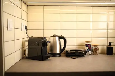 a kitchen counter with a coffee maker and a toaster at Le Centre Ville in Athens