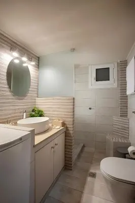a bathroom with a sink and a toilet and a mirror at Le Centre Ville in Athens