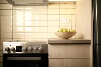 a bowl of fruit sitting on a counter next to a stove at Le Centre Ville in Athens