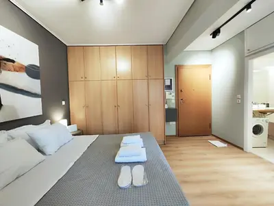 a bedroom with a bed with two pairs of shoes on it at Veno Donwtown in Athens