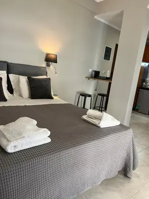 a bedroom with a bed with two towels on it at Living near Acropolis by Sylvia Staikou at Nikis str in Athens