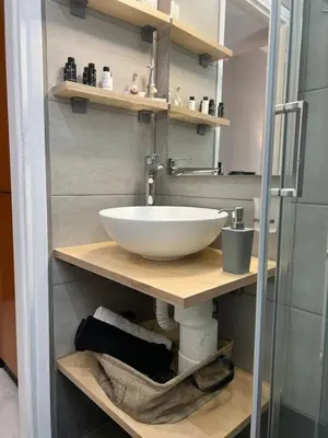 a bathroom with a white sink on a wooden shelf at Living near Acropolis by Sylvia Staikou at Nikis str in Athens