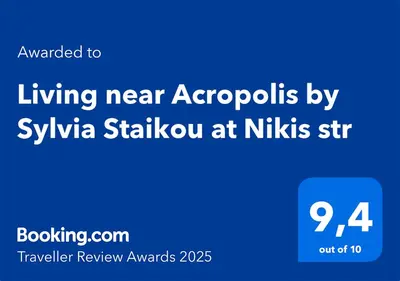 a blue sign with the text living near aeropolis by sylvania sk at Living near Acropolis by Sylvia Staikou at Nikis str in Athens