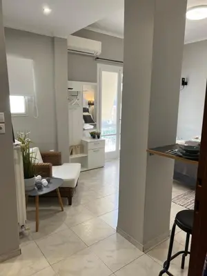a living room with a couch and a table at Living near Acropolis by Sylvia Staikou at Nikis str in Athens