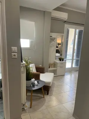 a living room with a white couch and a table at Living near Acropolis by Sylvia Staikou at Nikis str in Athens