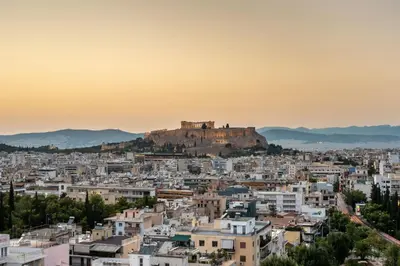a view ofhenshenshenshenshens city skyline at sunset at Kalypso, Urban Apartment with Unique Views of The Acropolis! in Athens