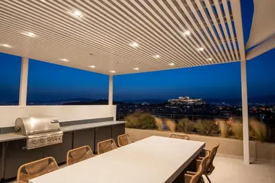 a kitchen with a table and chairs with a view at Kalypso, Urban Apartment with Unique Views of The Acropolis! in Athens