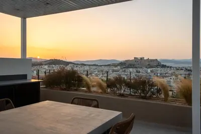 a room with a table and a view of a city at Kalypso, Urban Apartment with Unique Views of The Acropolis! in Athens