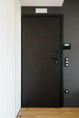 a black door in a room with a wooden floor at Kalypso, Urban Apartment with Unique Views of The Acropolis! in Athens