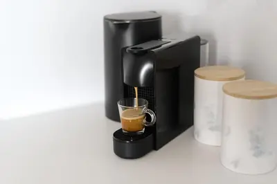 a coffee maker with a cup of coffee at Kalypso, Urban Apartment with Unique Views of The Acropolis! in Athens