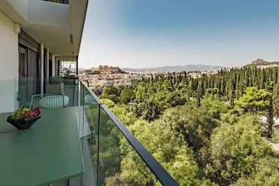 a balcony with a view of a city at Kalypso, Urban Apartment with Unique Views of The Acropolis! in Athens