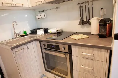 a small kitchen with a sink and a stove at Homeyfeel Stay Sea 1 - Modern studio next to the sea! in Porto Rafti