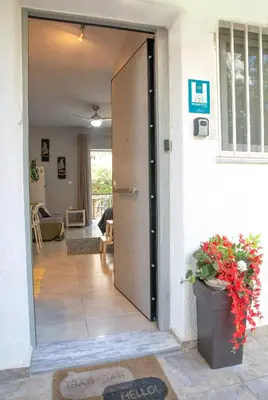 a door leading into a living room with a plant at Homeyfeel Stay Sea 1 - Modern studio next to the sea! in Porto Rafti