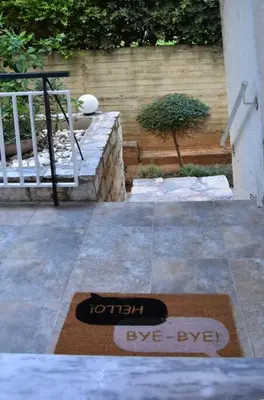 a welcome mat on the floor of a patio at Homeyfeel Stay Sea 1 - Modern studio next to the sea! in Porto Rafti