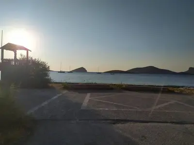 an empty parking lot next to the water at Homeyfeel Stay Sea 1 - Modern studio next to the sea! in Porto Rafti