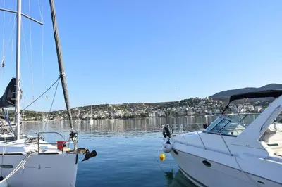 a white boat is docked in the water at Homeyfeel Stay Sea 1 - Modern studio next to the sea! in Porto Rafti