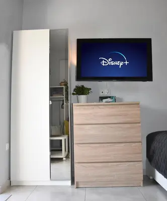 a tv on a wall above a dresser in a bedroom at Homeyfeel Stay Sea 1 - Modern studio next to the sea! in Porto Rafti