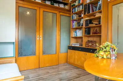 a room with a table and a book shelf at Sunny Apartment in Athens