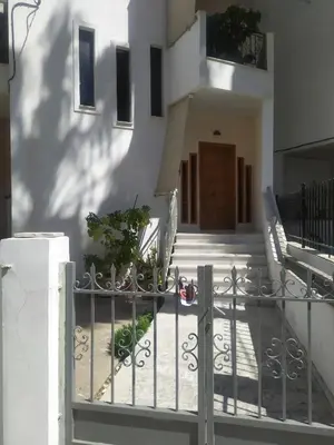 a gate in front of a building with stairs at Sunny Apartment in Athens