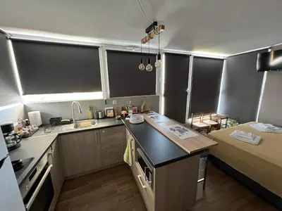 a small kitchen with a sink and a counter top at Square's View Agia Paraskevi in Athens