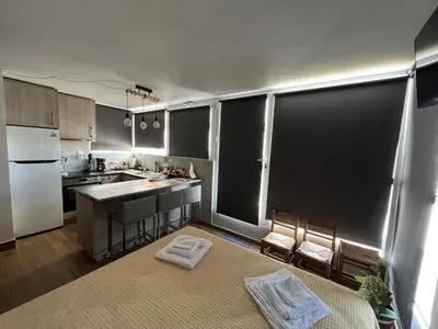 a small kitchen with a white refrigerator and a counter at Square's View Agia Paraskevi in Athens