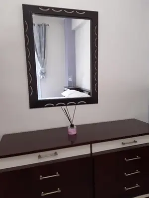 a mirror on top of a dresser in a room at Stylish apartment in Athens