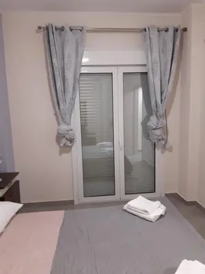 a bedroom with a sliding glass door with a window at Stylish apartment in Athens
