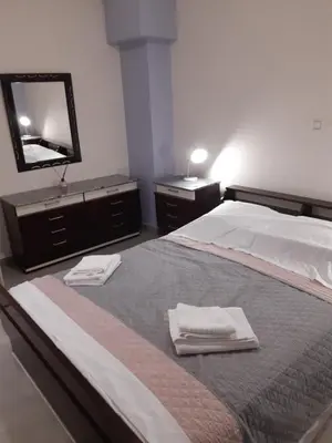 a bedroom with a bed with two towels and a mirror at Stylish apartment in Athens