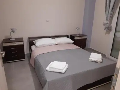 a bedroom with a bed with two towels on it at Stylish apartment in Athens