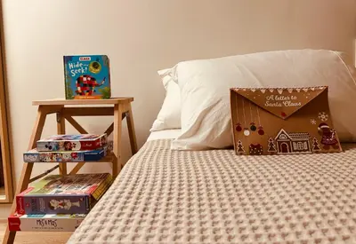 a bed with a box on it next to a side table at 2 BedRoom Apt - Live Like a Local in Kolonaki in Athens