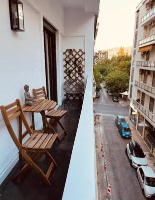 a balcony with two chairs and a table and a street at 2 BedRoom Apt - Live Like a Local in Kolonaki in Athens