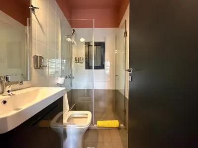 a bathroom with a shower and a toilet and a sink at M & M - boutique apartments in Athens
