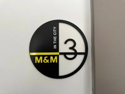 a black and white sign on a wall at M & M - boutique apartments in Athens