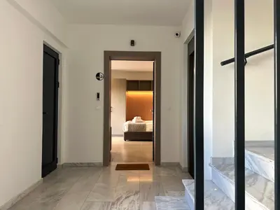 a hallway with a door leading to a bedroom at M & M - boutique apartments in Athens