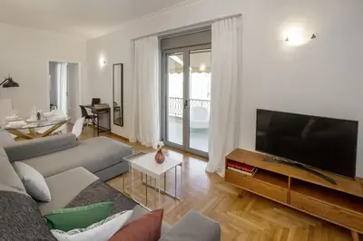 a living room with a couch and a flat screen tv at Syntagma Apartments with Acropolis view in Athens