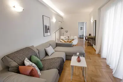 a living room with a couch and a table at Syntagma Apartments with Acropolis view in Athens