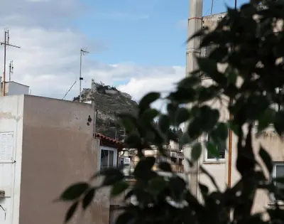 a building with a hill on top of it at Syntagma Apartments with Acropolis view in Athens
