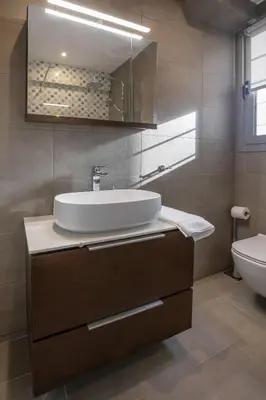 a bathroom with a sink and a toilet at Syntagma Apartments with Acropolis view in Athens