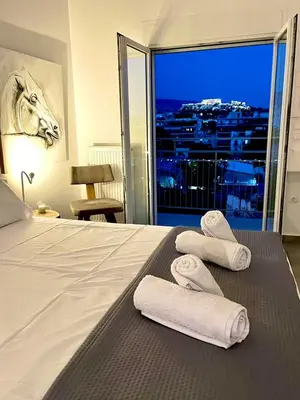 a hotel room with a bed with towels on it at Kalliopis Apartment in Athens