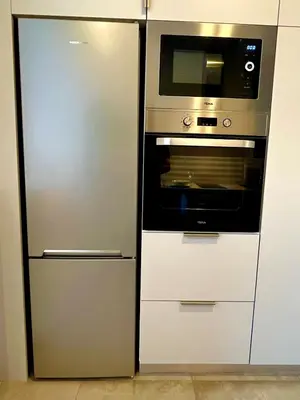a kitchen with a refrigerator and a microwave at Kalliopis Apartment in Athens