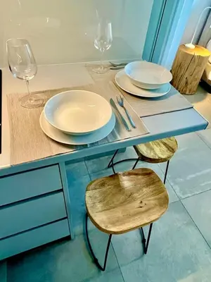 a table with two plates and two chairs with wine glasses at Kalliopis Apartment in Athens