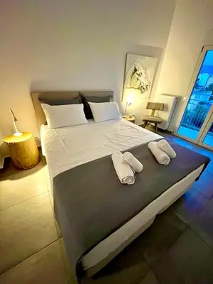 a bedroom with a large bed with two towels on it at Kalliopis Apartment in Athens