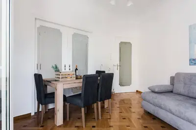 a dining room table with chairs and a couch at Diogenis' Jug in Athens