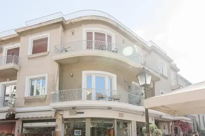 a large building with a balcony on top of it at Diogenis' Jug in Athens