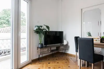a living room with a desk with a television on it at Diogenis' Jug in Athens