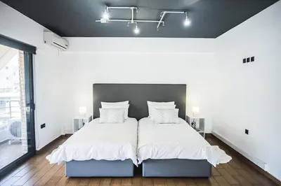 a bedroom with a large bed with white sheets and pillows at P & I in Athens