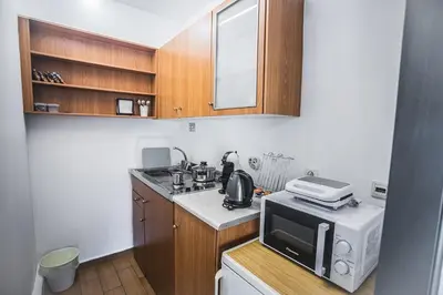a small kitchen with a microwave and a stove at P & I in Athens