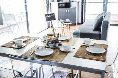 a dining table with plates and cups on it at P & I in Athens
