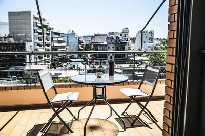 a table and chairs on a balcony with a view at P & I in Athens